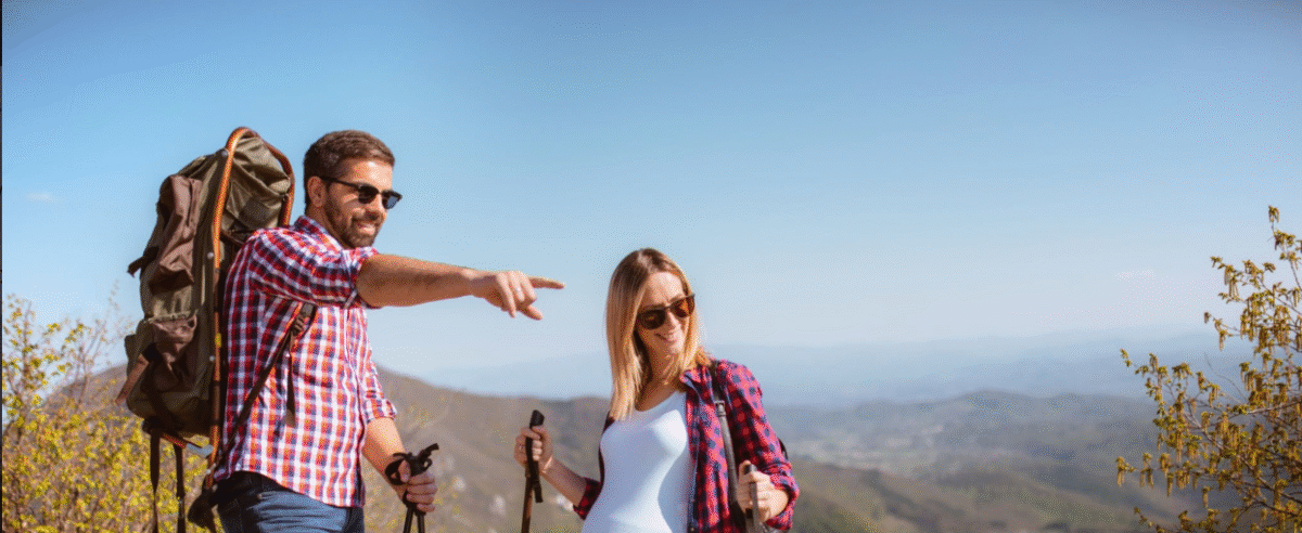 Pregnant gorilla trekking mountain gorillas from safe distance during forest tour